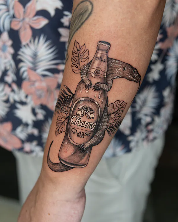 Monitor lizard on Chang beer bottle forearm tattoo Bangkok by Ballin