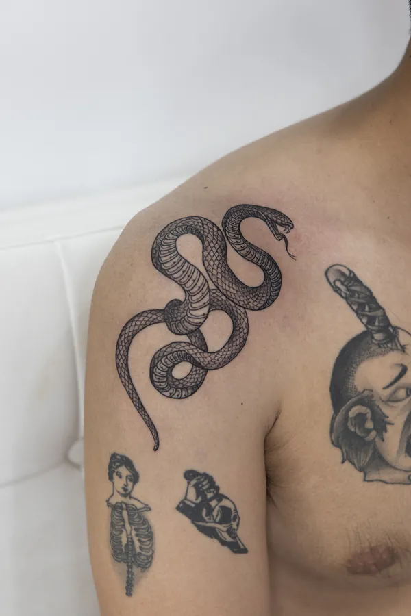 Coiled snake shoulder tattoo Bangkok by Ballin