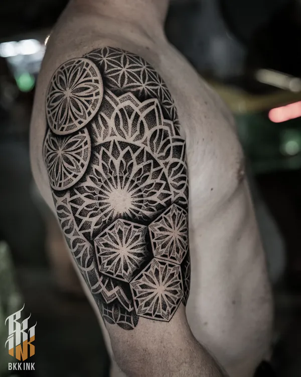 Layered floral disc shoulder blackwork tattoo Bangkok