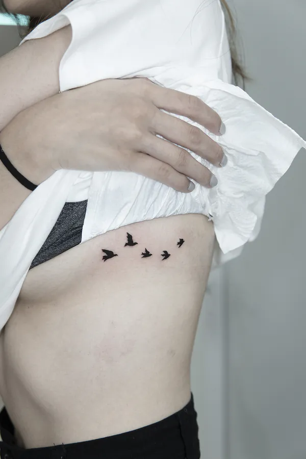 Flying birds flock ribs feminine girly tattoo Bangkok