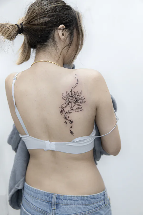 Fine line chrysanthemum upper back feminine tattoo Bangkok