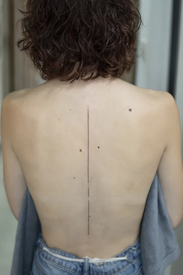 Minimalist single line spine feminine tattoo Bangkok