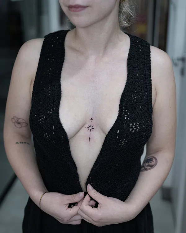 Tiny star compass sternum feminine tattoo Bangkok