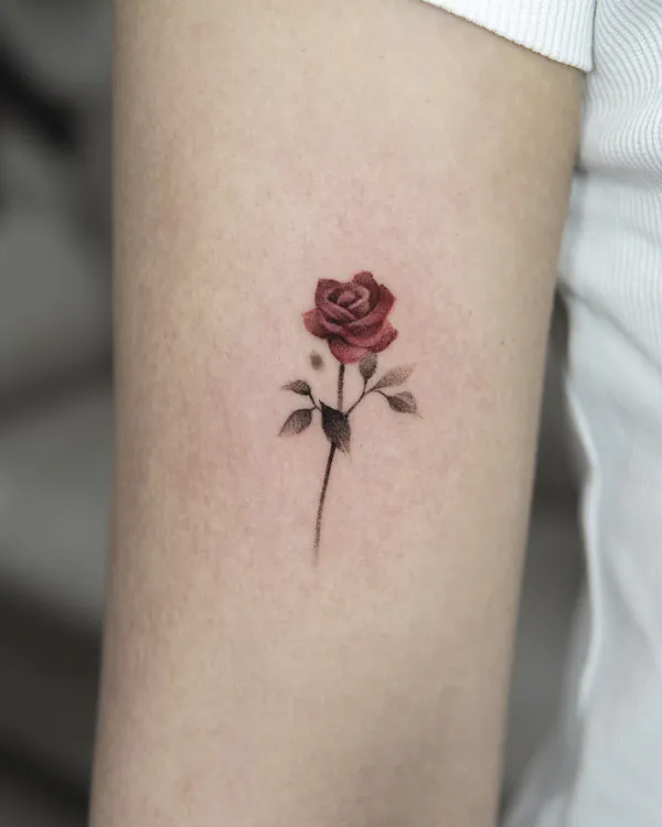 Small red rose upper arm feminine girly tattoo Bangkok