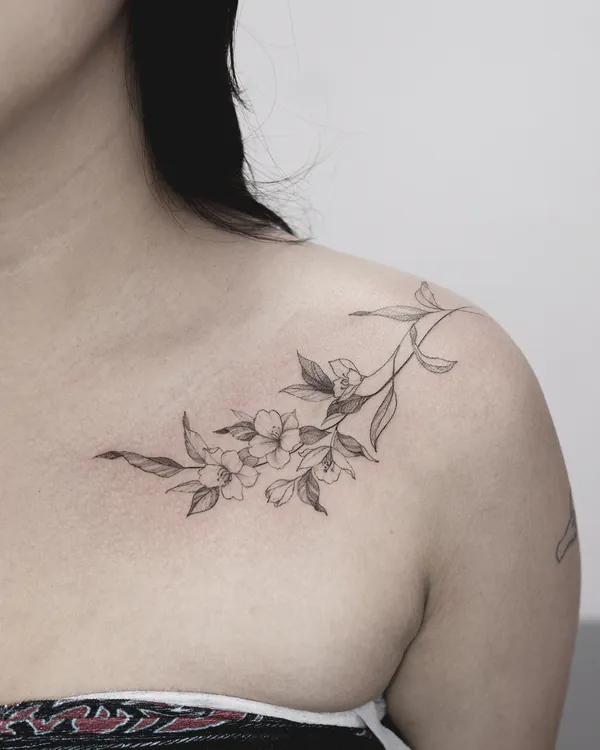 Cherry blossom branch collarbone feminine girly tattoo Bangkok