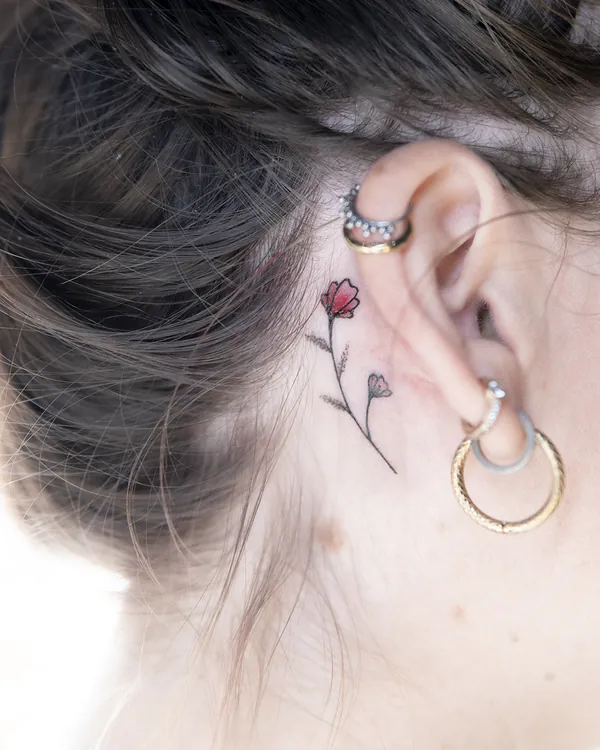 Small red flower behind ear feminine girly tattoo Bangkok