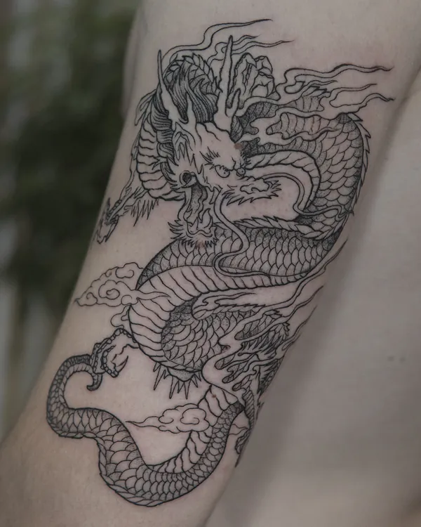 Chinese dragon upper arm fine line tattoo Bangkok
