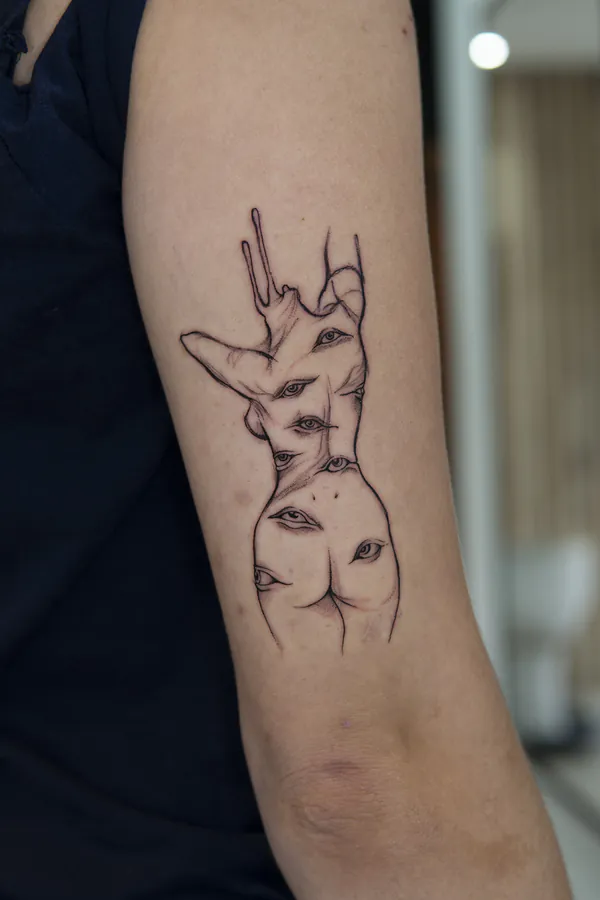 Surreal multi eye figure upper arm fine line tattoo Bangkok