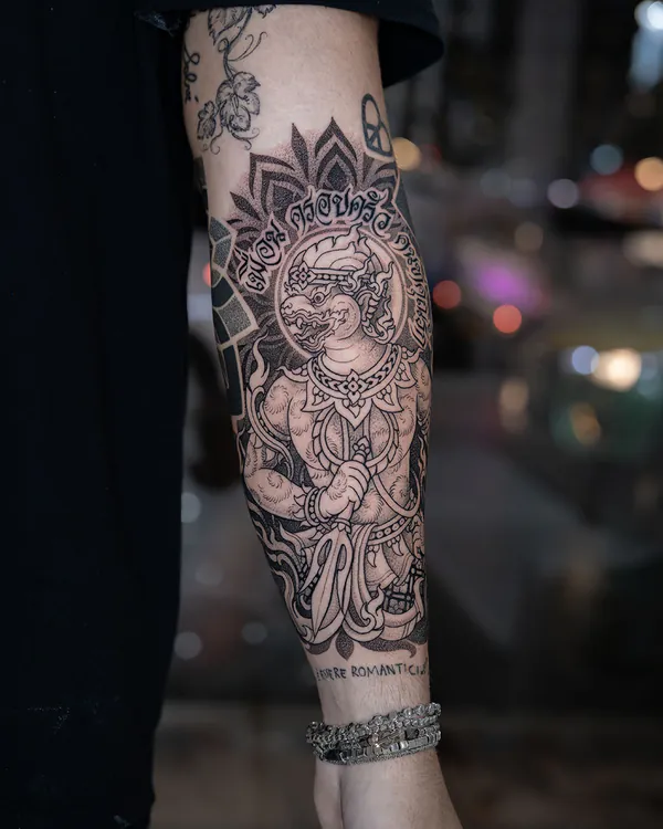 Thai deity mandala with lettering forearm tattoo Bangkok by Jack