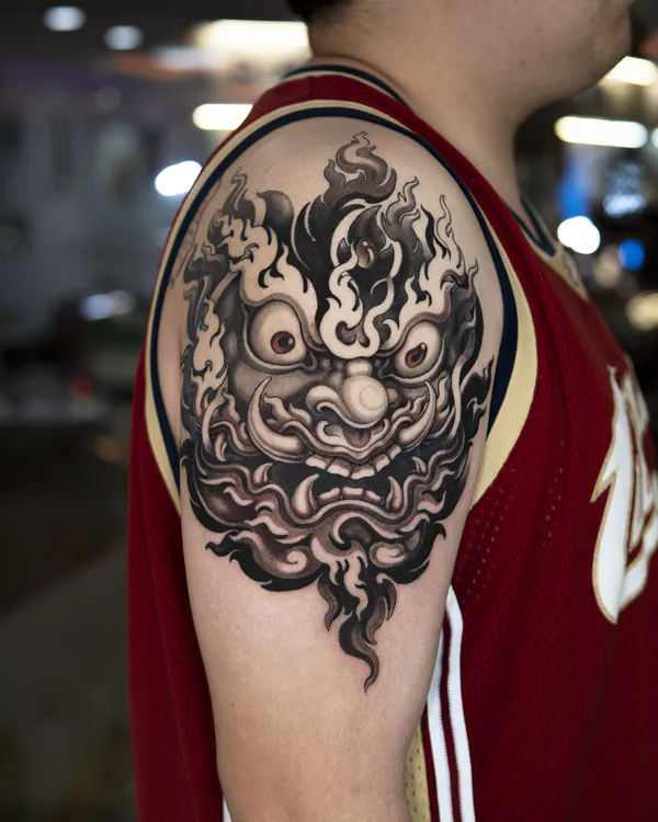 Black and grey oni mask shoulder tattoo Bangkok by Jack