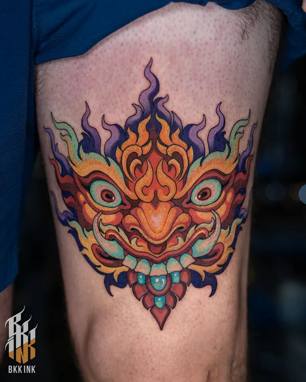 Colorful demon face thigh tattoo Bangkok by Jack