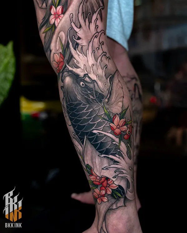 Koi fish and red flowers calf Japanese tattoo Bangkok