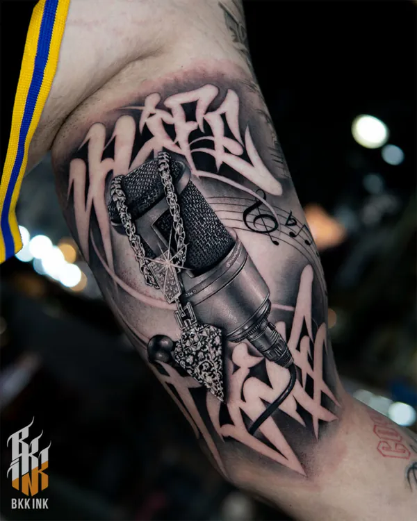 Chicano graffiti script bicep lettering tattoo Bangkok