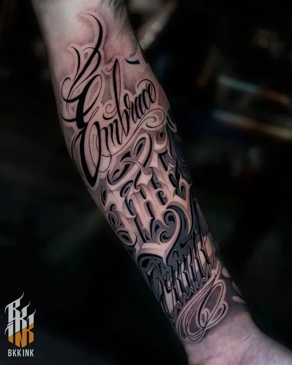 Ornate chicano cursive forearm lettering tattoo Bangkok
