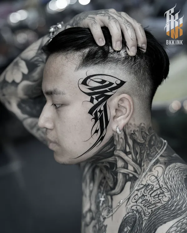 Bold tribal calligraphy side head lettering tattoo Bangkok