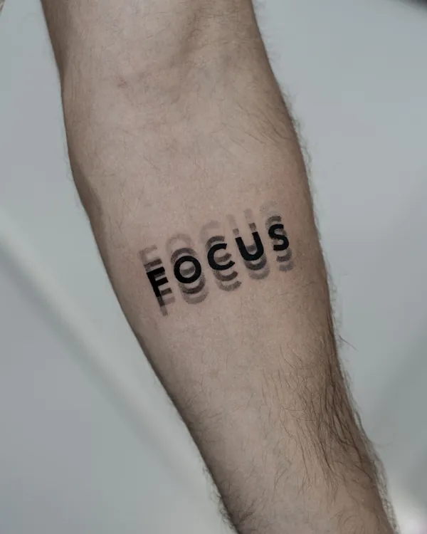 Bold motion-blur word forearm lettering tattoo Bangkok