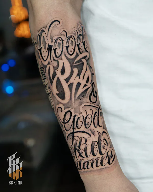 Layered chicano cursive forearm lettering tattoo Bangkok