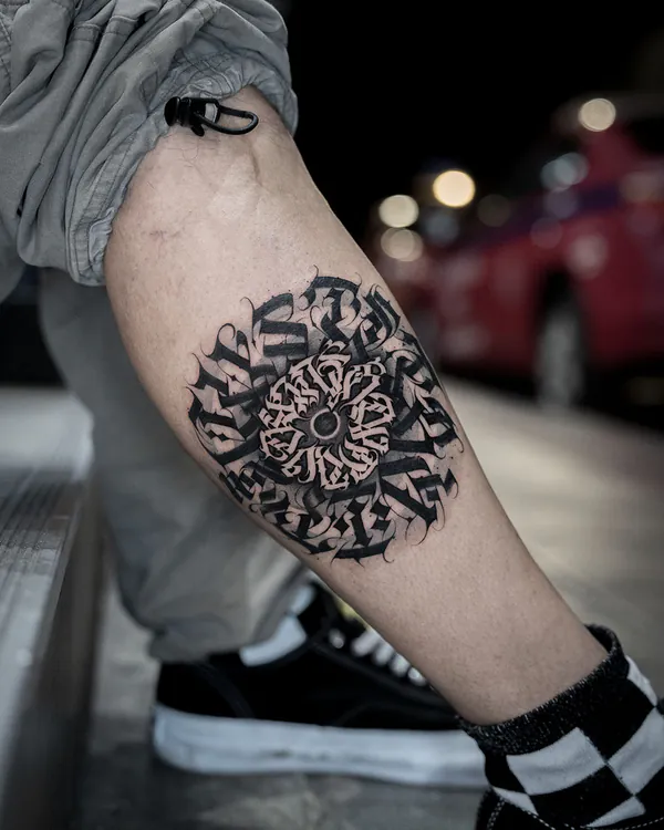 Circular mandala calligraphy calf lettering tattoo Bangkok