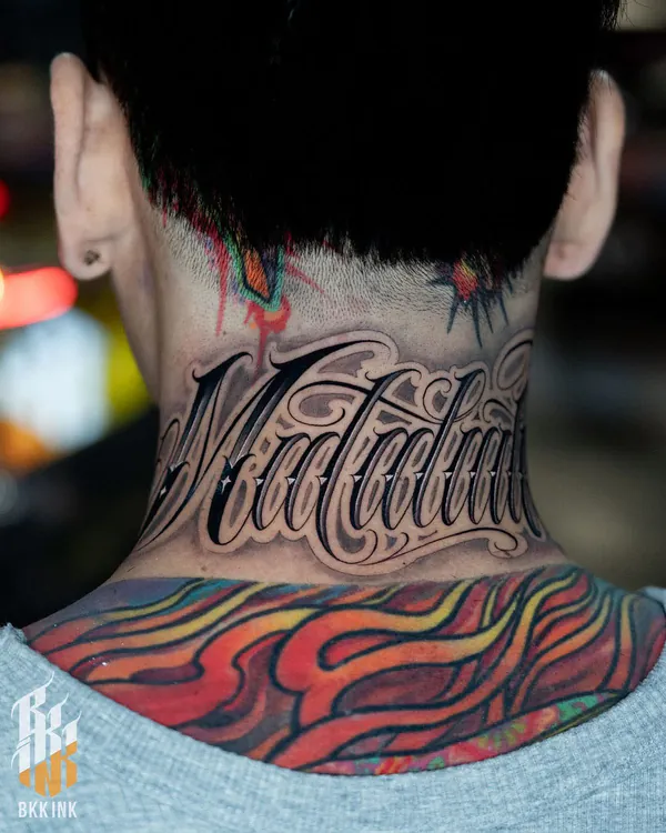 Bold cursive script nape lettering tattoo Bangkok