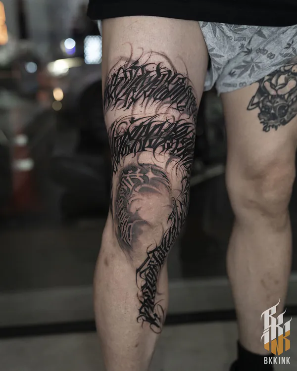 Gothic script leg wrap lettering tattoo Bangkok
