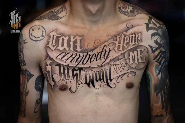 Banner script full chest lettering tattoo Bangkok