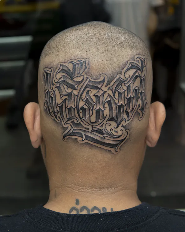 Old English blackletter back head lettering tattoo Bangkok