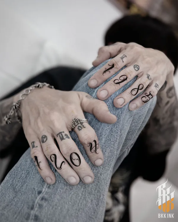 Fine script finger knuckle lettering tattoo Bangkok
