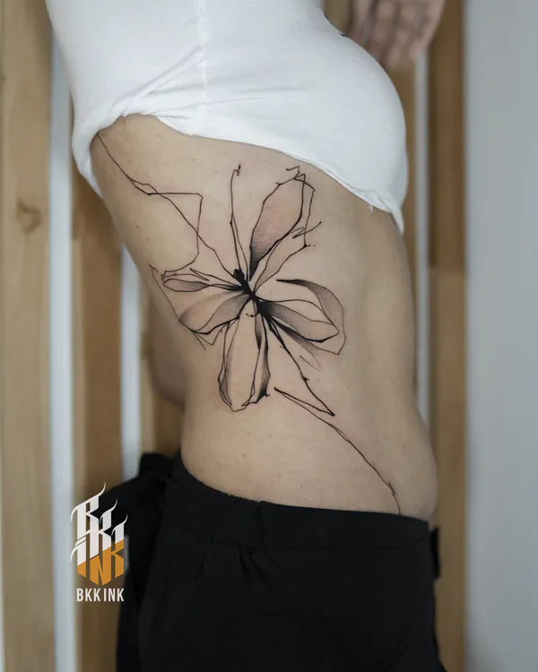 Abstract line-art orchid flower rib tattoo Bangkok by Mo