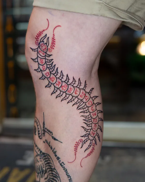Thai sak yant centipede knee tattoo Bangkok by Mor