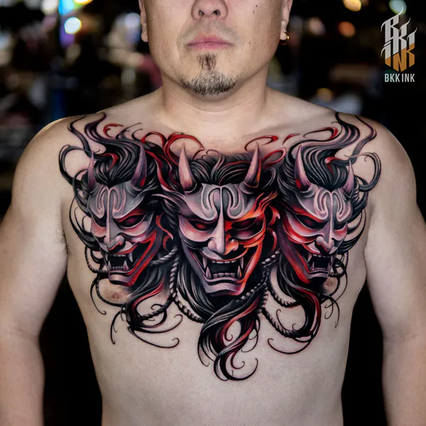 Black and grey trio of hannya masks chest piece neo-traditional tattoo Bangkok