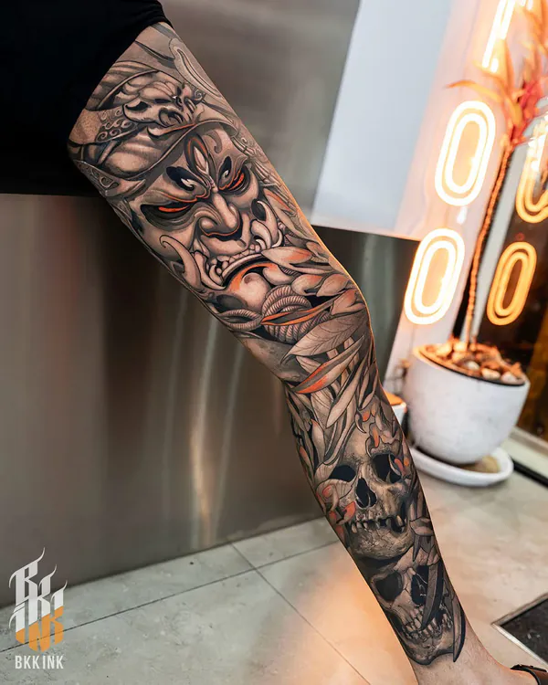 Black and grey samurai mask with skulls leg sleeve neo-traditional tattoo Bangkok
