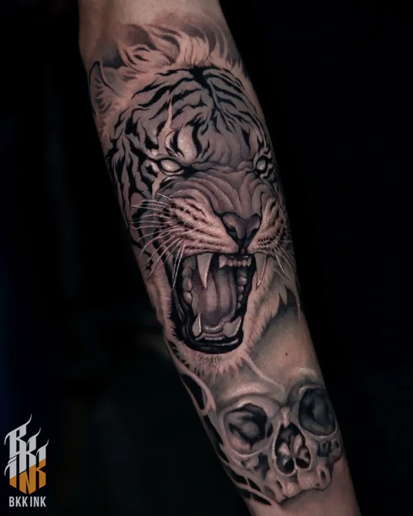 Black and grey roaring tiger head with skull forearm neo-traditional tattoo Bangkok