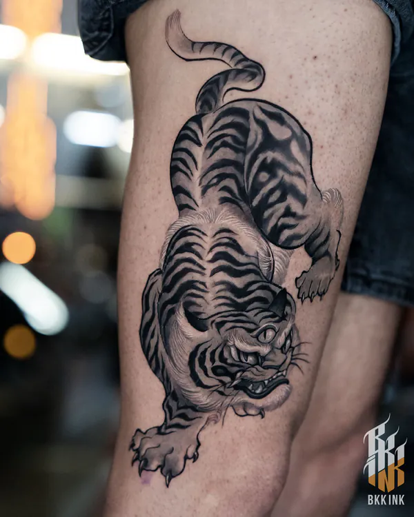 Black and grey crouching tiger full thigh neo-traditional tattoo Bangkok