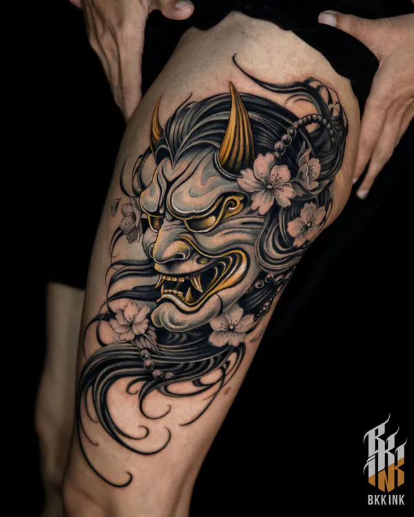 Colour hannya mask with cherry blossoms thigh neo-traditional tattoo Bangkok