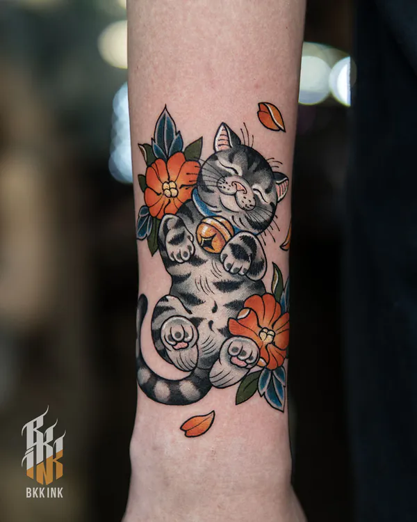 Colour grey cat playing with bell forearm neo-traditional tattoo Bangkok