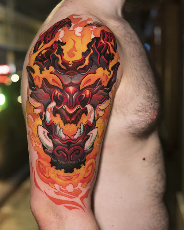 Fiery oni demon mask upper arm new school tattoo Bangkok