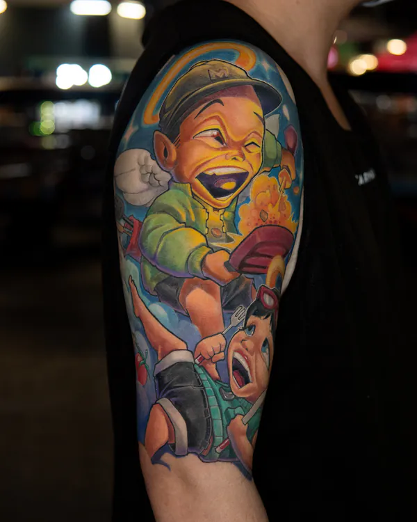 Laughing cartoon boy eating scene upper arm new school tattoo Bangkok