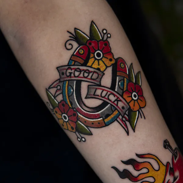 Horseshoe with flowers forearm old school tattoo Bangkok