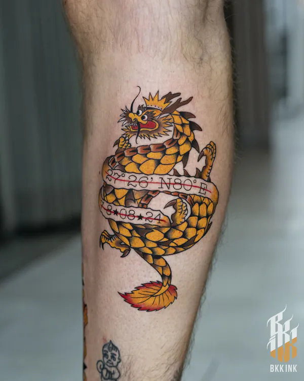 Coiled dragon with coordinates calf old school tattoo Bangkok