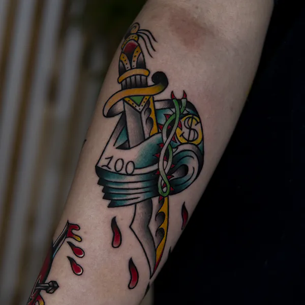 Dagger through dollar bills forearm old school tattoo Bangkok