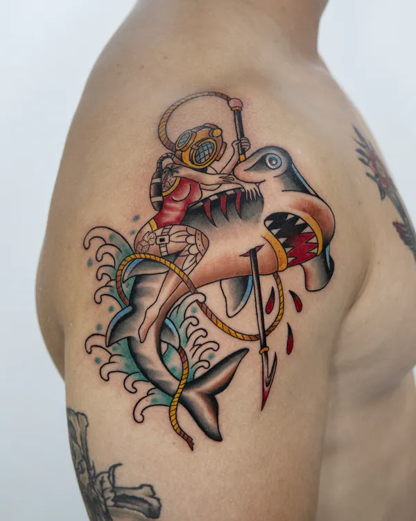 Diver fighting shark shoulder old school tattoo Bangkok