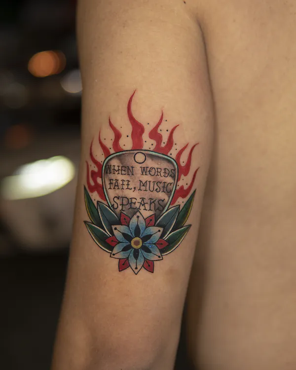 Guitar pick with flames and flower arm old school tattoo Bangkok