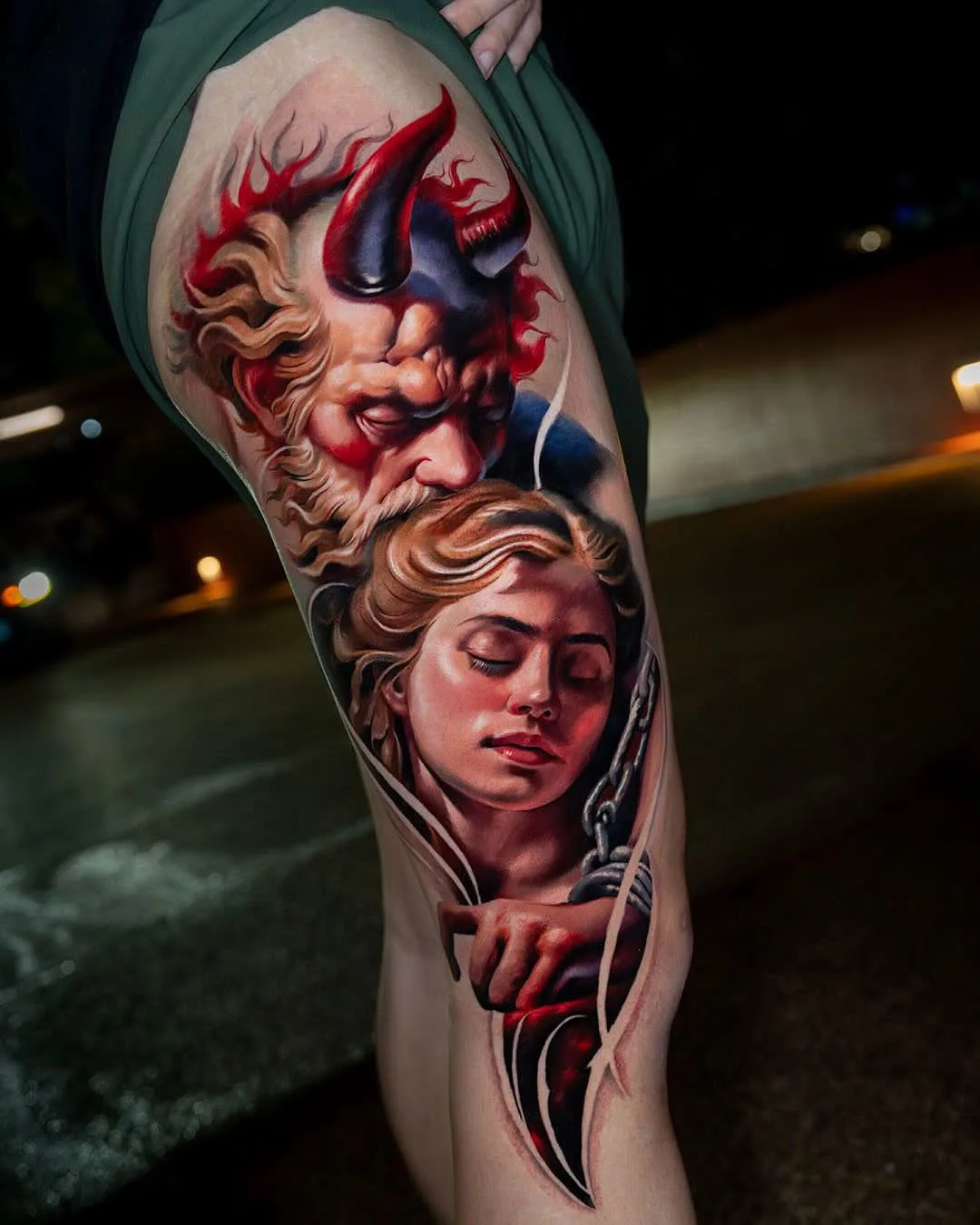 Colour demon and chained woman portrait thigh realistic tattoo Bangkok
