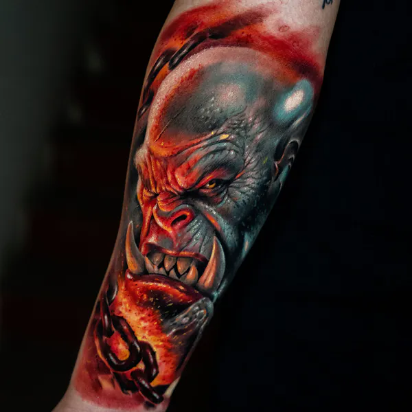 Colour orc face with chains forearm realistic tattoo Bangkok