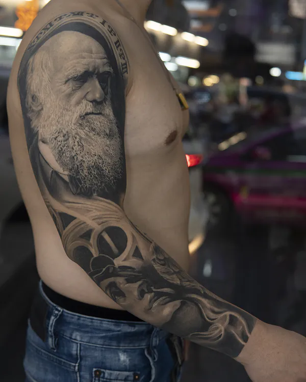 Elderly bearded man portrait upper arm realistic tattoo Bangkok