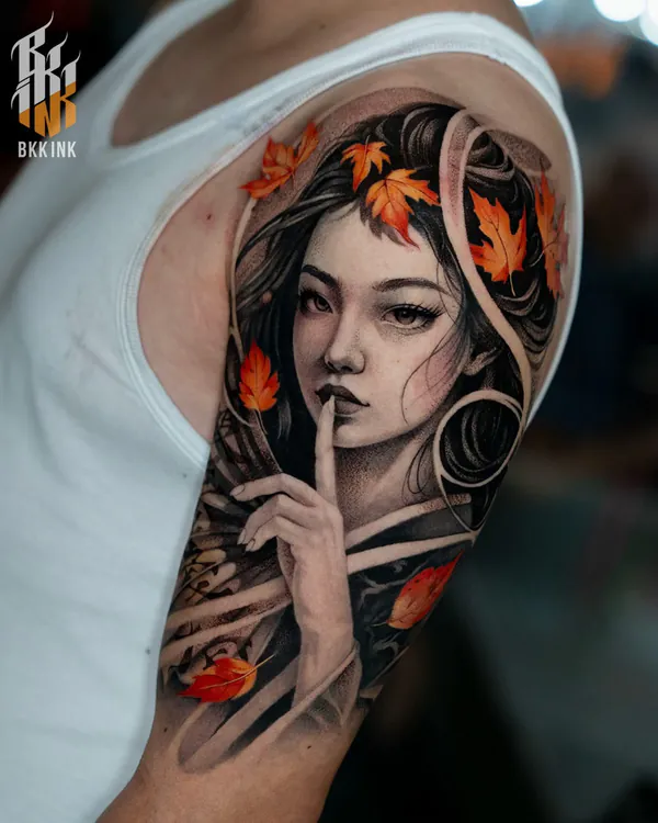 Colour woman with autumn leaves upper arm realistic tattoo Bangkok