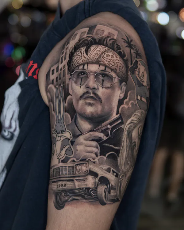 Colour man portrait with cartoon characters upper arm realistic tattoo Bangkok