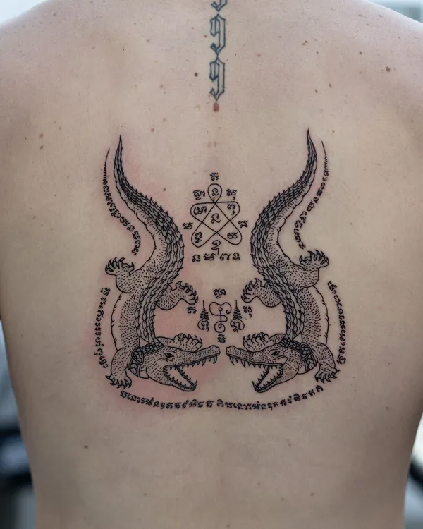 Twin crocodiles upper back Sak Yant tattoo Bangkok