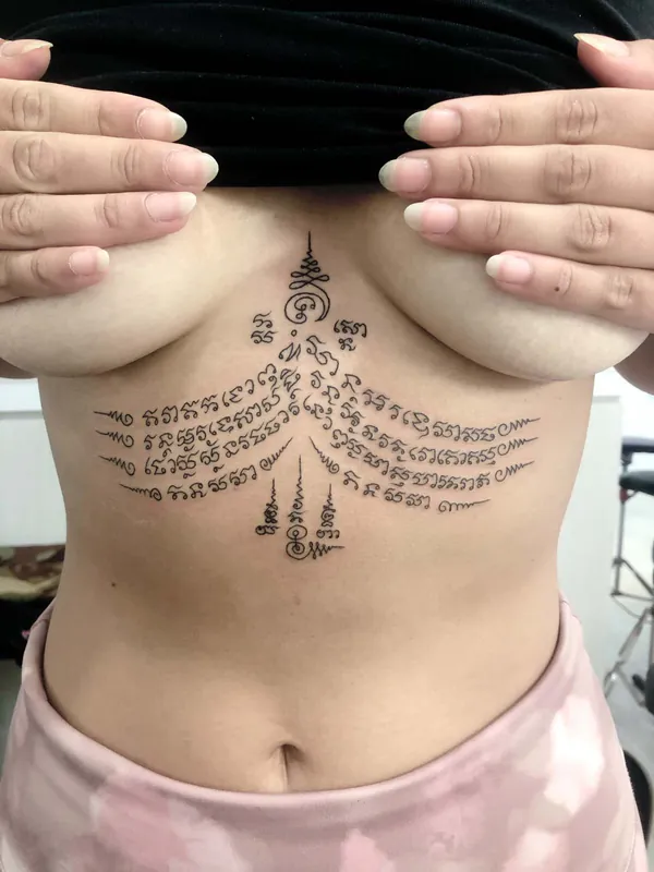 Geometric yant script underbust Sak Yant tattoo Bangkok