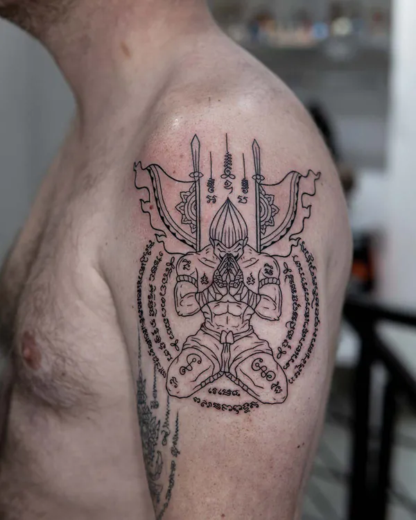 Kneeling deity spears shoulder Sak Yant tattoo Bangkok